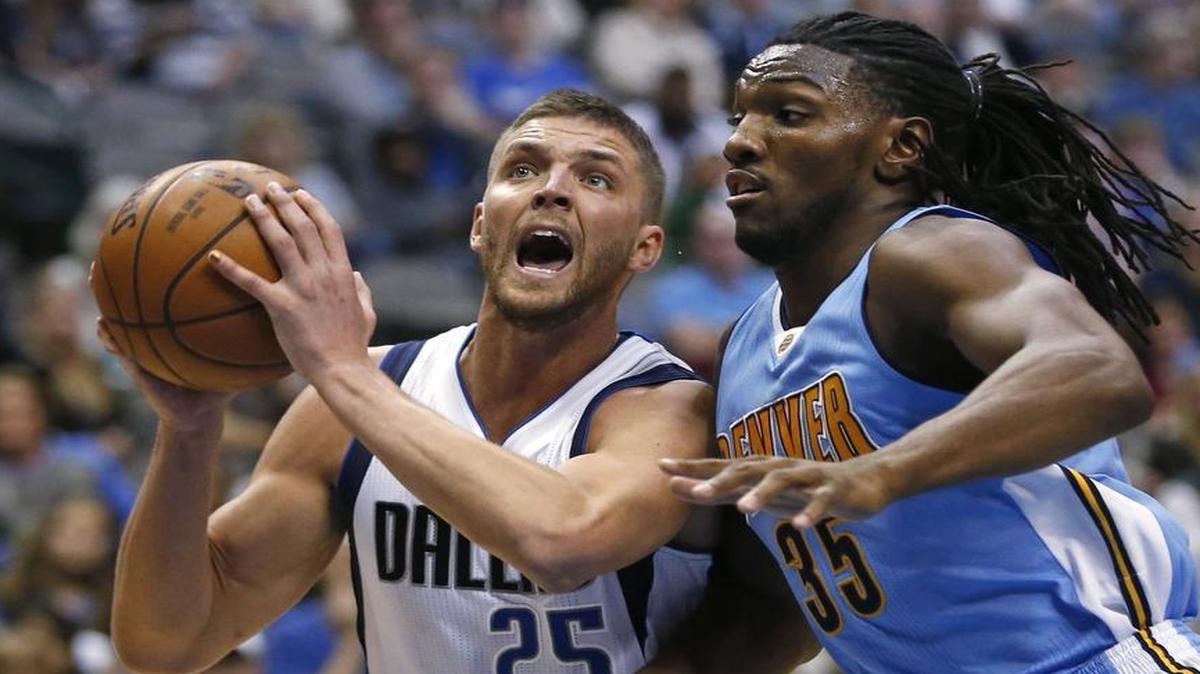 Dallas Mavericks forward Chandler Parsons (25) drives inside next to Denver Nuggets forward Kenneth Faried (35) during the second half.
