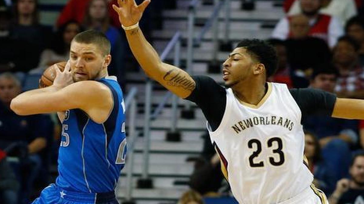Dallas Mavericks forward Chandler Parsons grabs a rebound under pressure from New Orleans Pelicans forward Anthony Davis (23) in the first half of an NBA basketball game in New Orleans, Wednesday, Jan. 6, 2016.