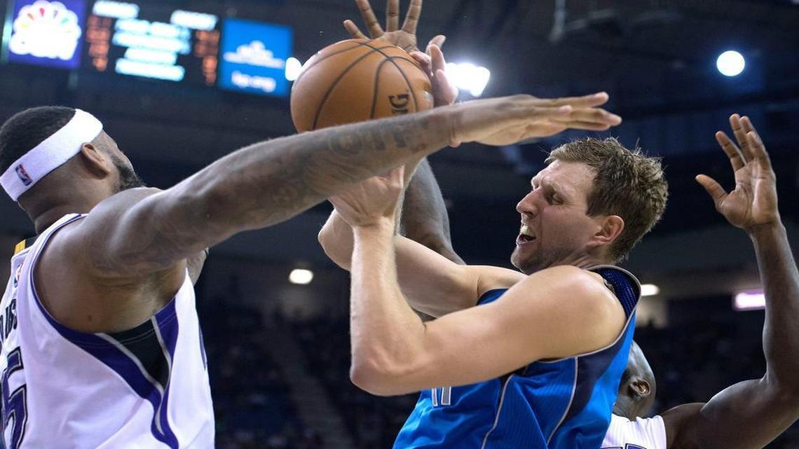 Dallas Mavericks forward Dirk Nowitzki is fouled by Sacramento Kings center DeMarcus Cousins (15) during the third quarter.
