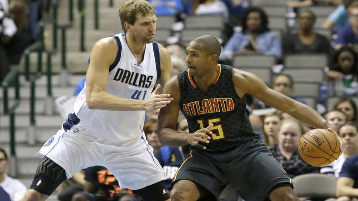 
Atlanta Hawks forward Al Horford (15) dribbles against Dallas Mavericks forward Dirk Nowitzki of Germany during the first half of an NBA preseason basketball game Friday. 
