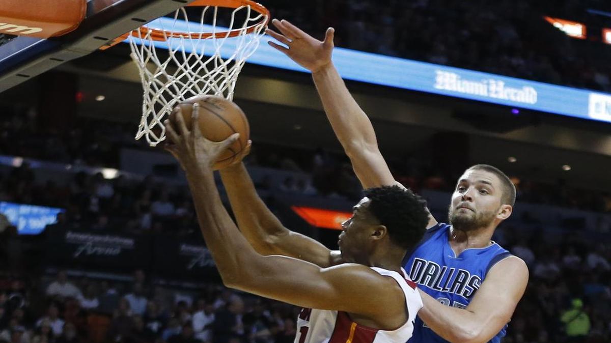 Heat center Hassan Whiteside, left, had 25 points and 19 rebounds to lead Miami to a 106-82 victory over the Mavericks and Chandler Parsons on Jan. 1.