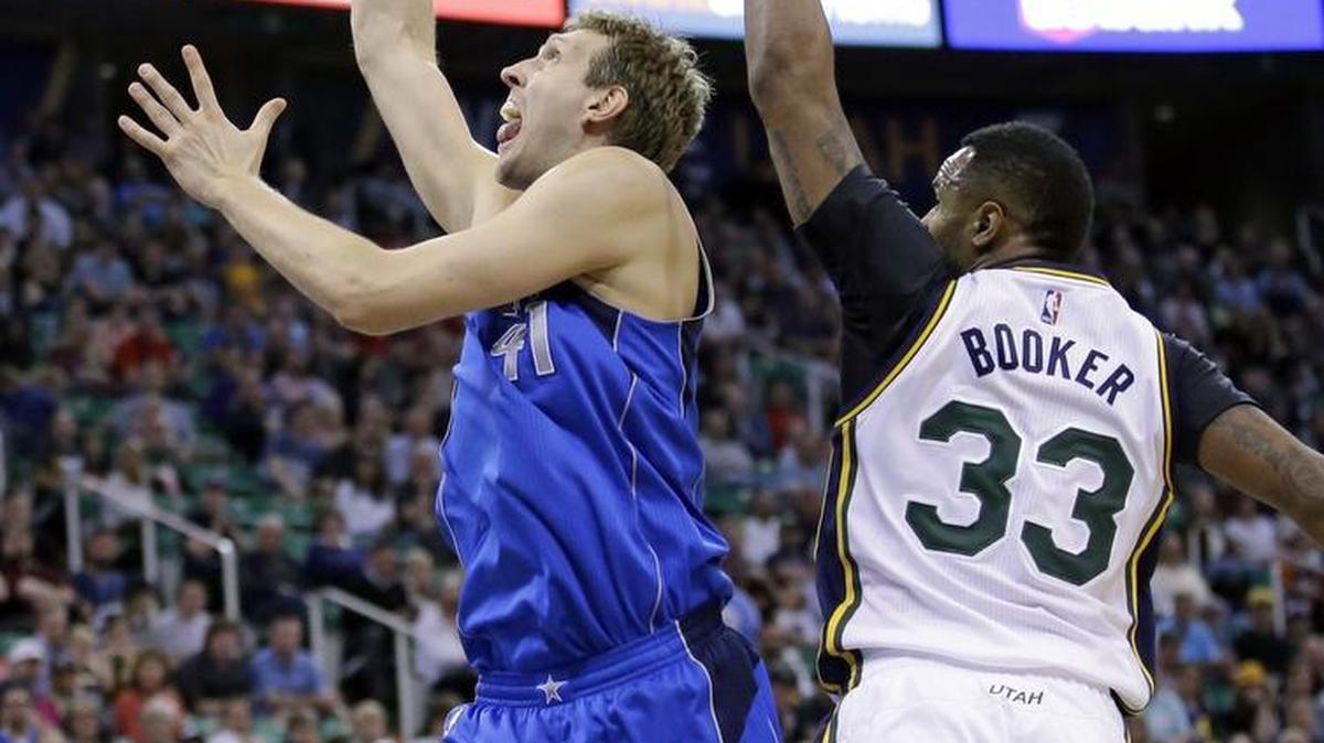 Dirk Nowitzki scored 22 points against Trevor Booker and the Utah Jazz to help the Mavericks to a 99-92 victory and a spot in the NBA playoffs.