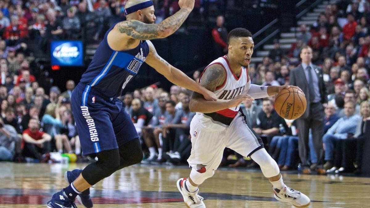 Trail Blazers guard Damian Lillard, right, scored a game-high 27 points to lead Portland past Deron Williams and the Dallas Mavericks 109-103 late Wednesday.