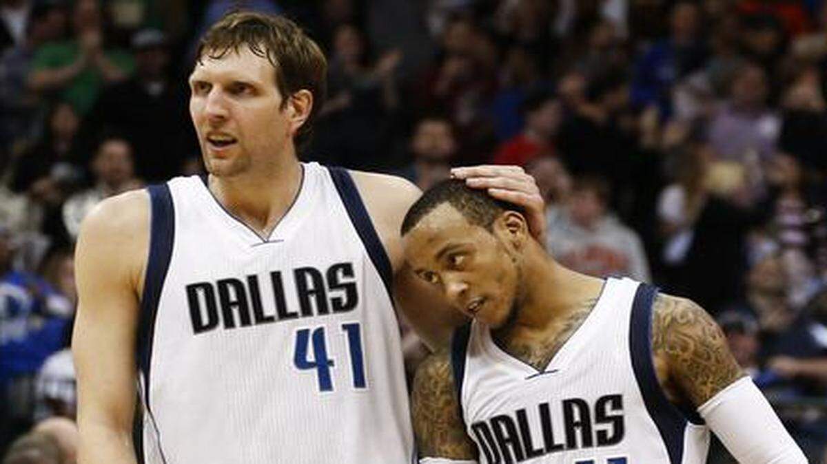 
 Mavericks forward Dirk Nowitzki, left, congratulates guard Monta Ellis (11) after Ellis scored against the Portland Trail Blazers during overtime Saturday. 
