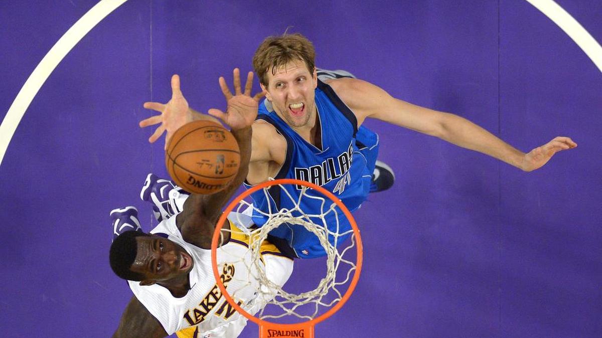 Dirk Nowitzki, right, scored a game-high 25 points and had nine rebounds to help the Mavericks keep Brandon Bass and the Lakers at bay Sunday night.
