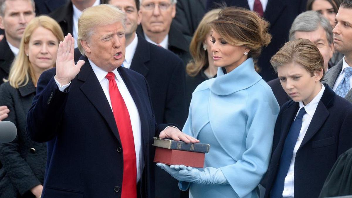 Donald Trump, left, takes the oath of office as his wife and son look on. President Trump and Dallas Mavericks owner Mark Cuban did some verbal jousting during the presidential campaign.
