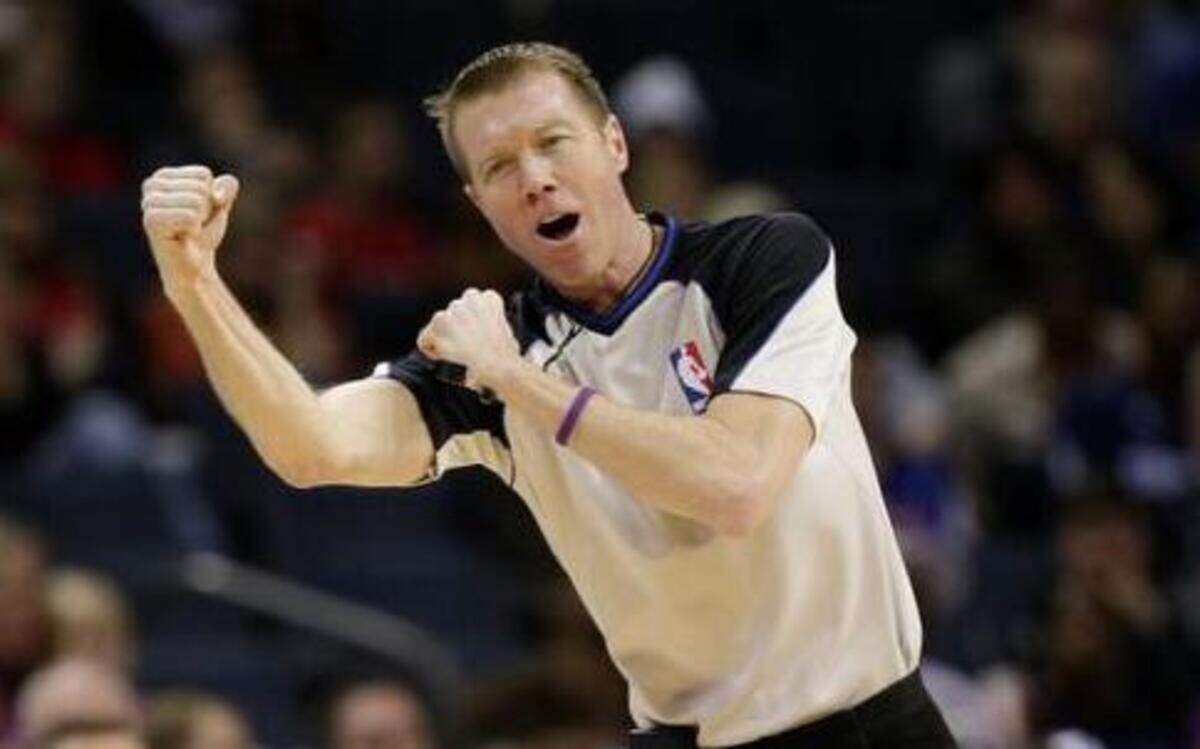 
Referee Ed Malloy makes a charging call during an NBA game. The block/charge call is one of the most difficult to make in basketball.
