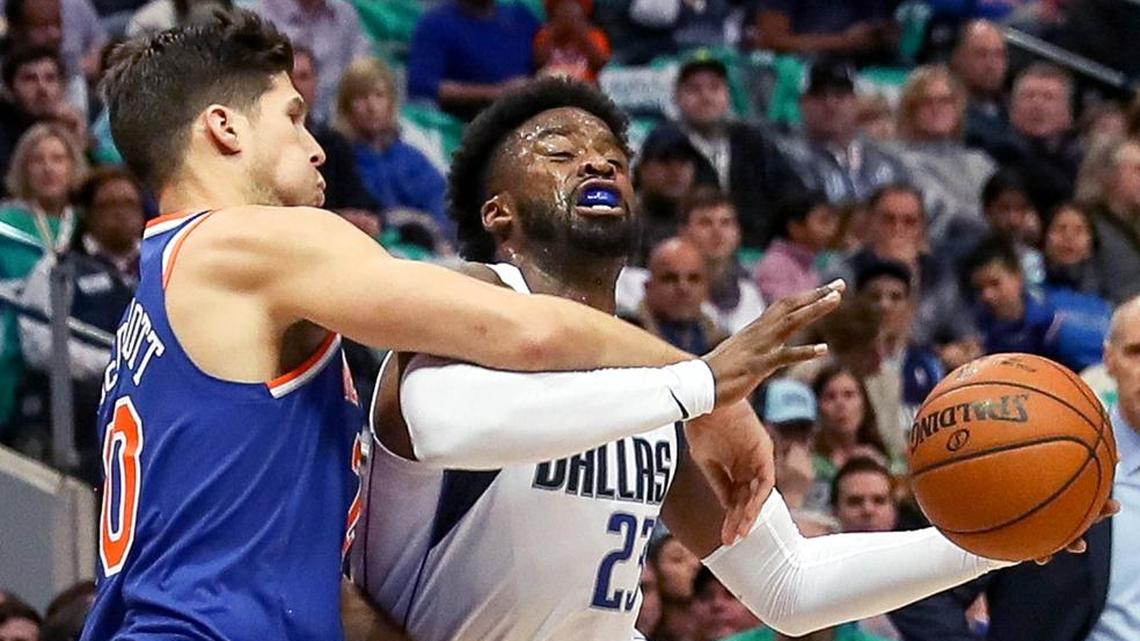 Dallas Mavericks guard Wesley Matthews (23) gets fouled by Knicks forward Doug McDermott during the first half Sunday in Dallas.