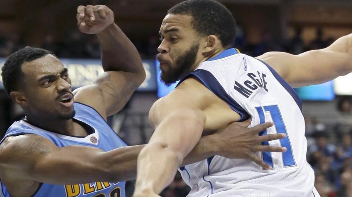 Dallas Mavericks center JaVale McGee defends against the Denver Nuggets’ Darrell Arthur. McGee provides the potential for Dallas to improve on offense and defense.
