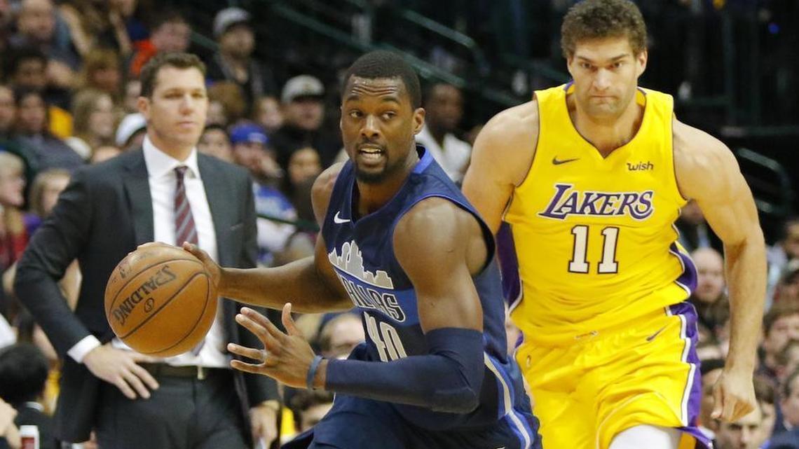 Mavericks forward Harrison Barnes (40) steals the ball as Los Angeles Lakers center Brook Lopez chases him and Lakers coach Luke Walton watches Saturday in Dallas.