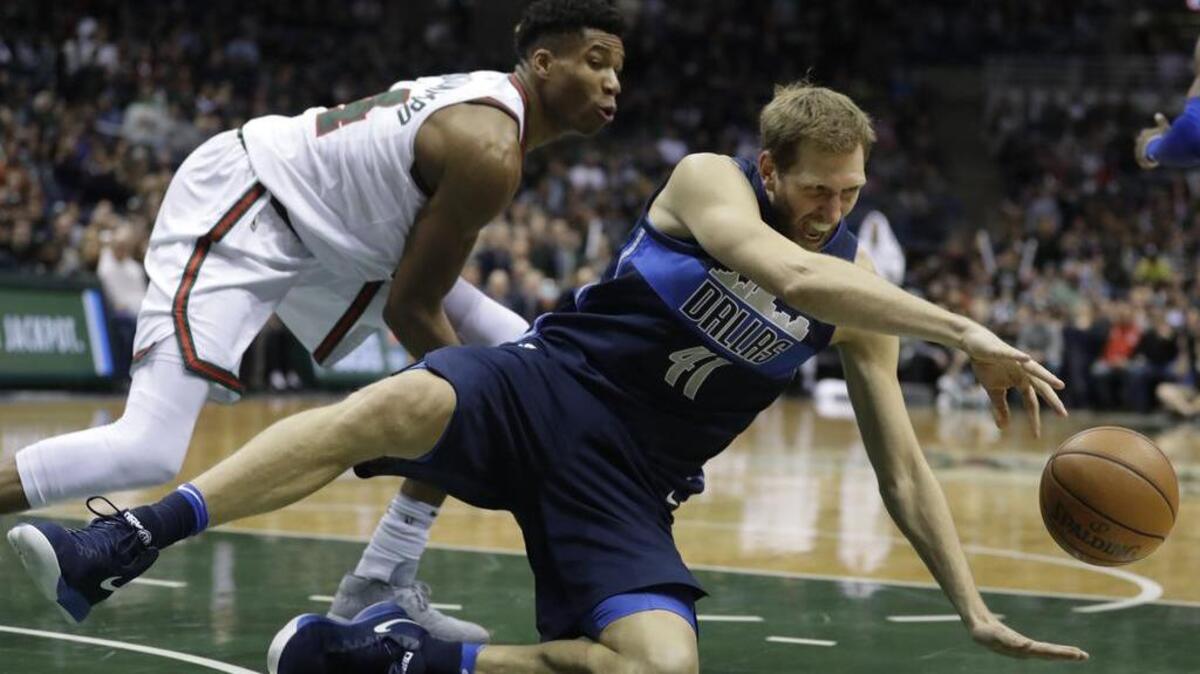 Dallas Mavericks’ Dirk Nowitzki loses the ball in front of Milwaukee Bucks’ Giannis Antetokounmpo during the second half.