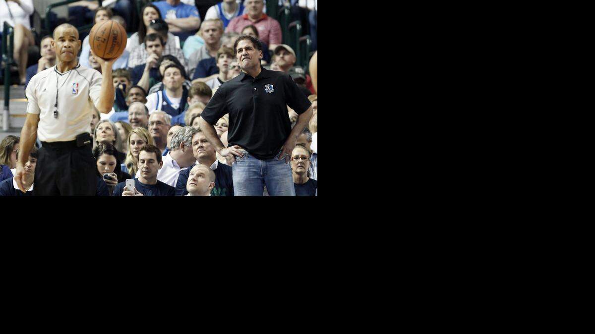 
Dallas Mavericks owner Mark Cuban, right, argues a call during the first half of an NBA basketball game against the San Antonio Spurs, Tuesday, March 24, 2015, in Dallas. Dallas won 101-94.
