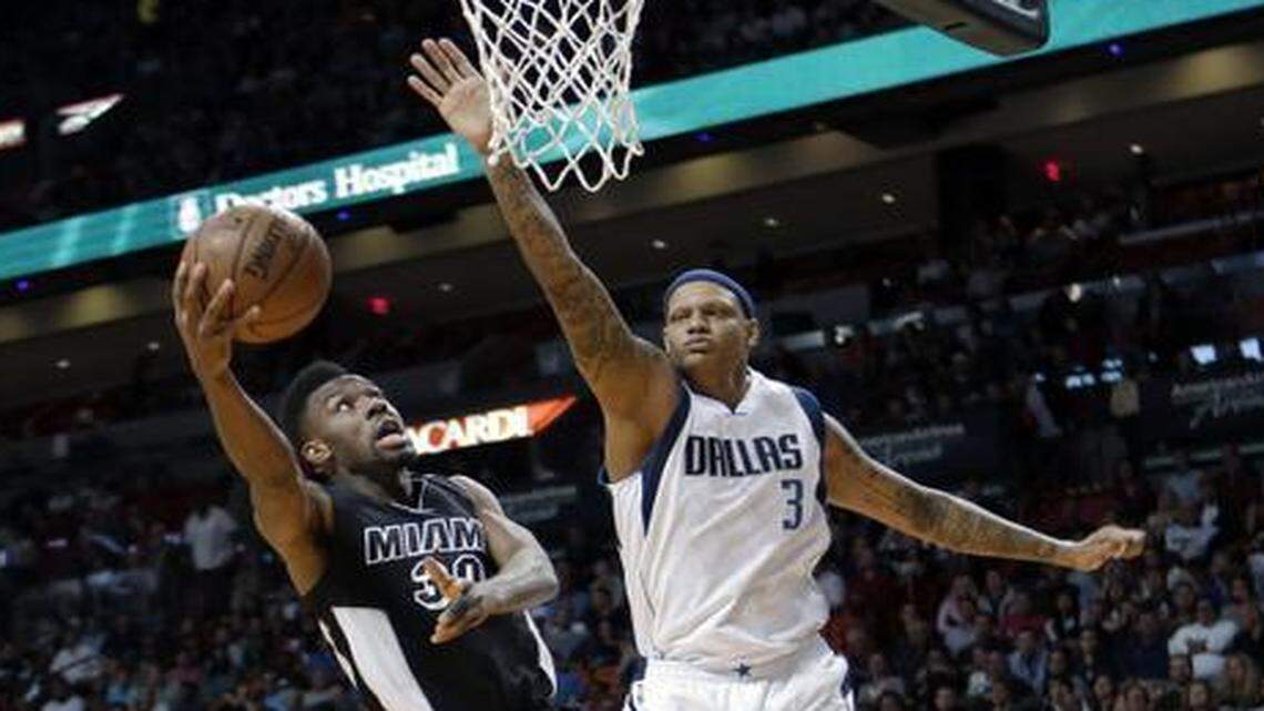
Charlie Villanueva, right, and the Mavericks kept the pressure on Norris Cole and the Heat, helping Rick Carlisle win No. 600.


