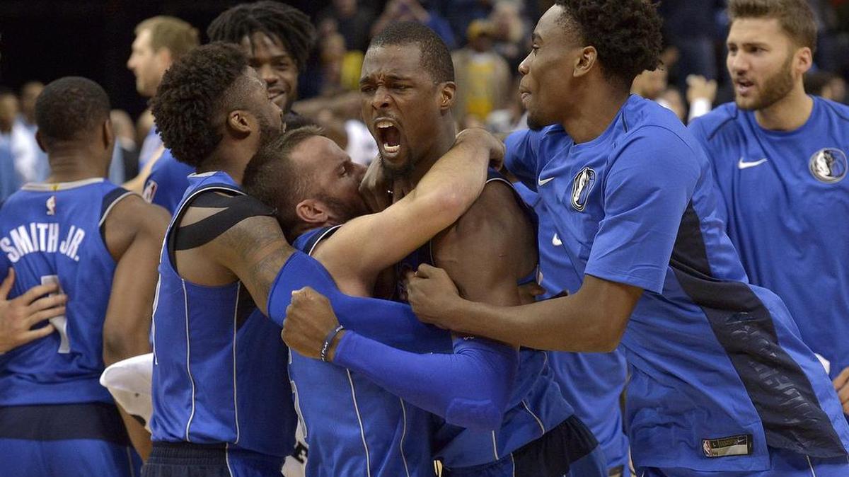Teammates congratulate Dallas Mavericks forward Harrison Barnes, center, after he scored a game-winning three point shot at the buzzer to beat the Grizzlies 95-94 in Memphis on Wednesday.