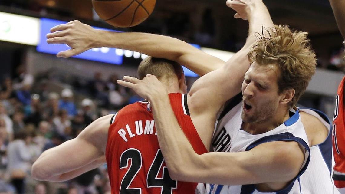 Portland Trail Blazers forward Mason Plumlee, left, fouls Dallas Mavericks forward Dirk Nowitzki during the first half Sunday in Dallas.