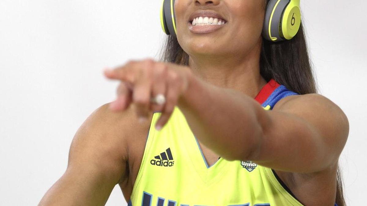 Dallas Wings guard Skylar Diggins-Smith (4) sings along to a song on the headphones, part of one of the team’s videos being filmed at Media Day on May 2, 2017.