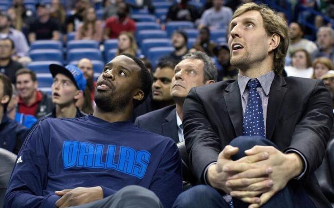 Dallas Mavericks forwards Wesley Matthews, left, and Dirk Nowitzki watch from the bench during the second half against the New Orleans Pelicans in New Orleans on Wednesday. Four of the Mavericks starters wre rested, but Dallas won 100-91.