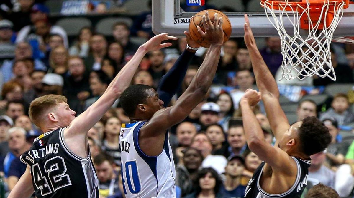 Dallas Mavericks forward Harrison Barnes, middle, put up a shot despite the defensive efforts of Spurs Davis Bertans, left, and Kyle Anderson in their game Nov. 30 in Dallas.