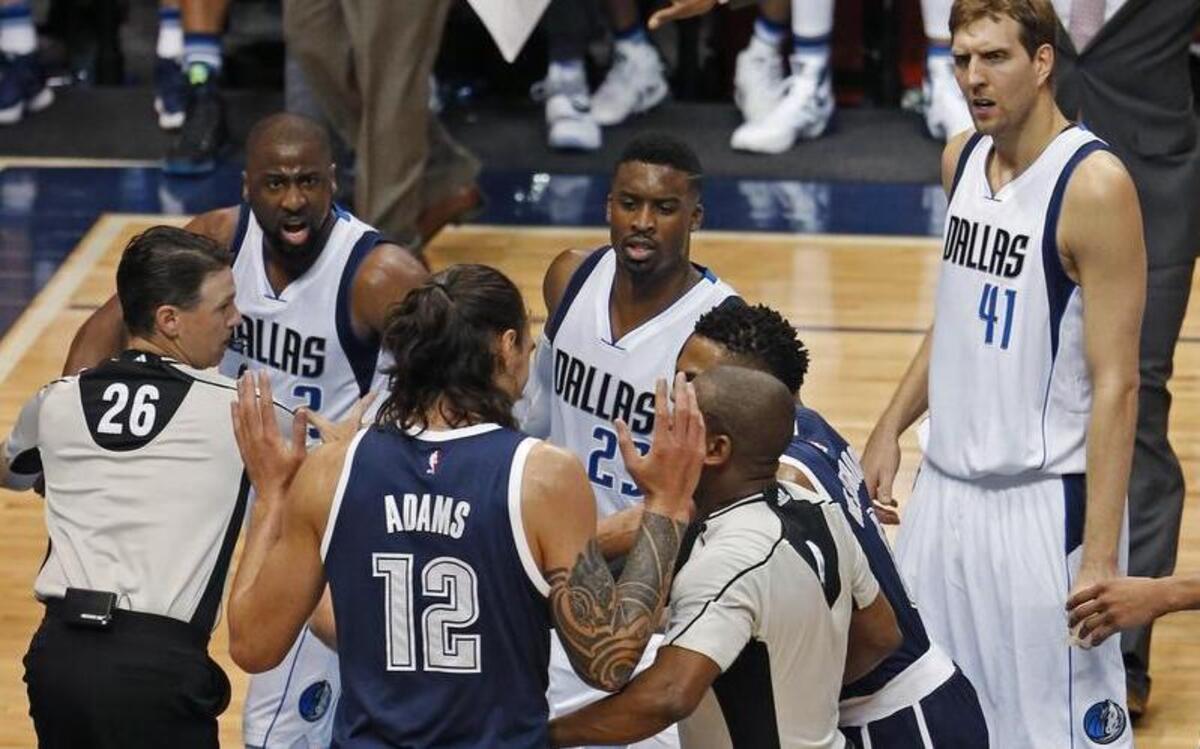 As Dallas Mavericks guard Raymond Felton (2, background) yells at Oklahoma City Thunder center Steven Adams (12) as teammates and officials scramble to keep the two apart in the third period.