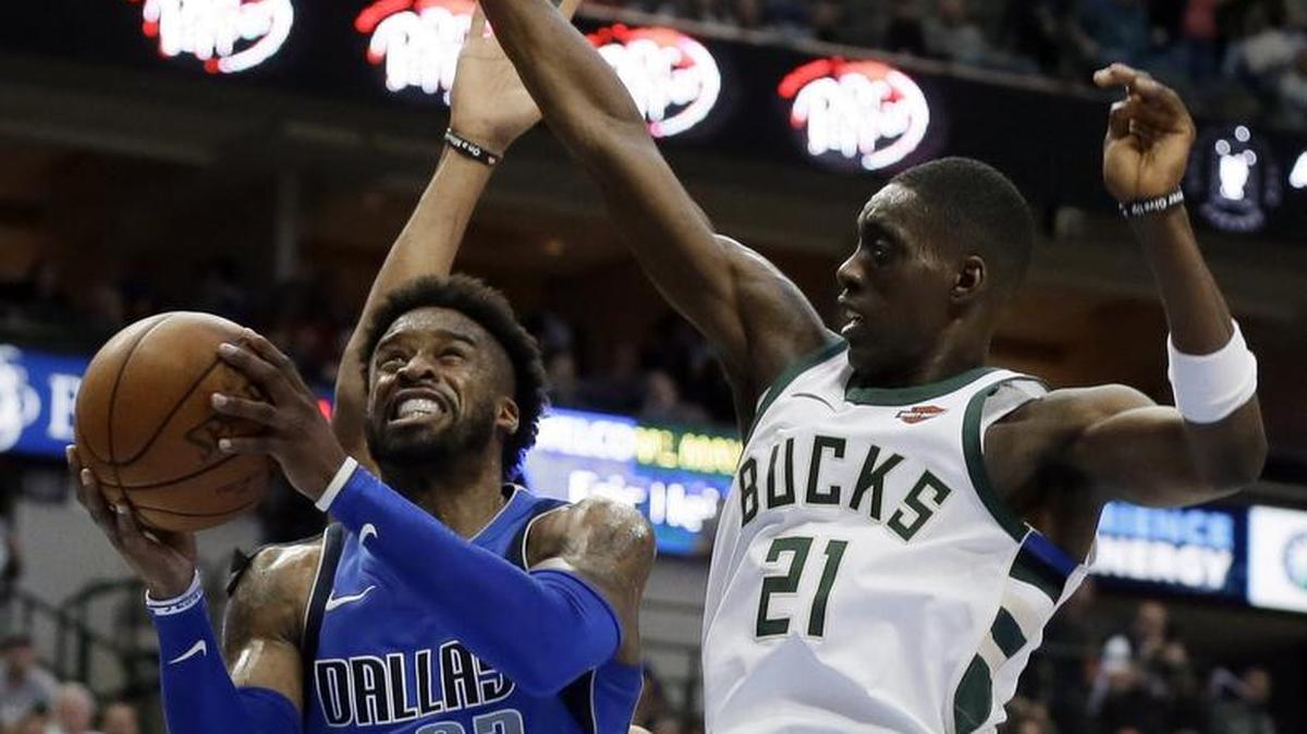 Wesley Matthews, left, finished with a season-high 22 points to help lift the Mavericks past Tony Snell and the Bucks 111-79 Saturday night in Dallas.
