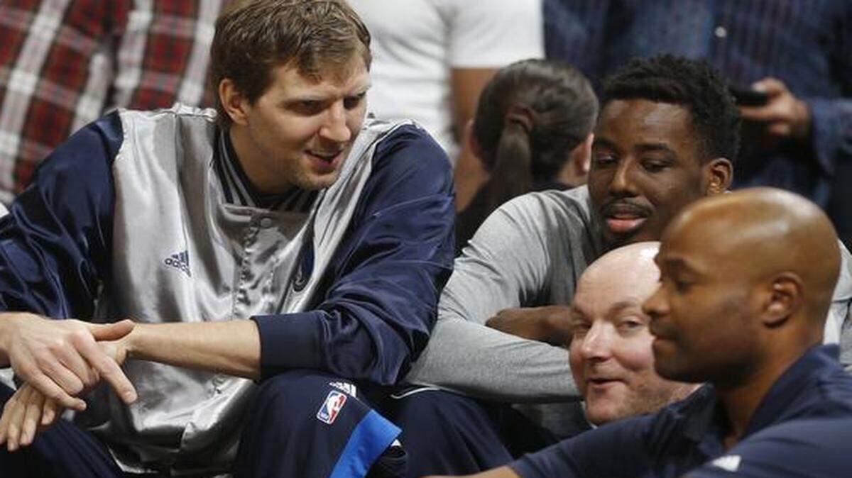 
Dallas Mavericks forward Dirk Nowitzki, left, jokes with forward Al-Farouq Aminu as they watch from the bench Wednesday night in Denver. Nowitzki sat out the game against the Nuggets after an overtime win Tuesday night at Sacramento. 
