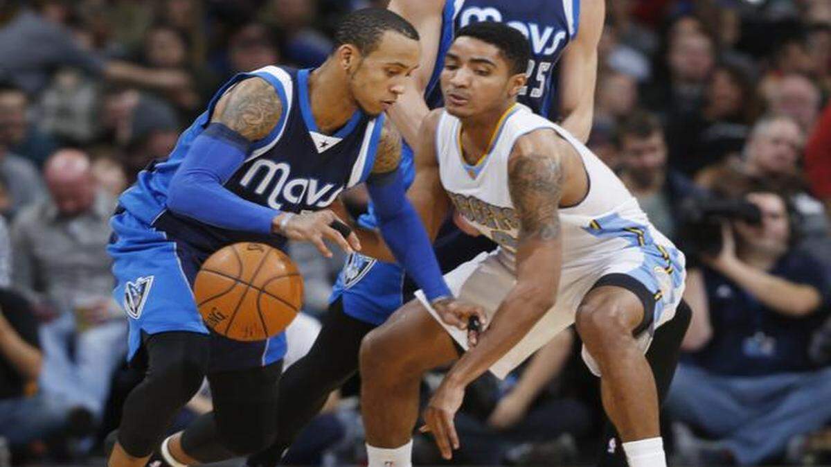 
Dallas Mavericks guard Monta Ellis, left, loses the ball as Denver Nuggets guard Gary Harris defends during the third quarter of Wednesday’s game in Denver. The Nuggets defeated the Mavericks 114-107. 
