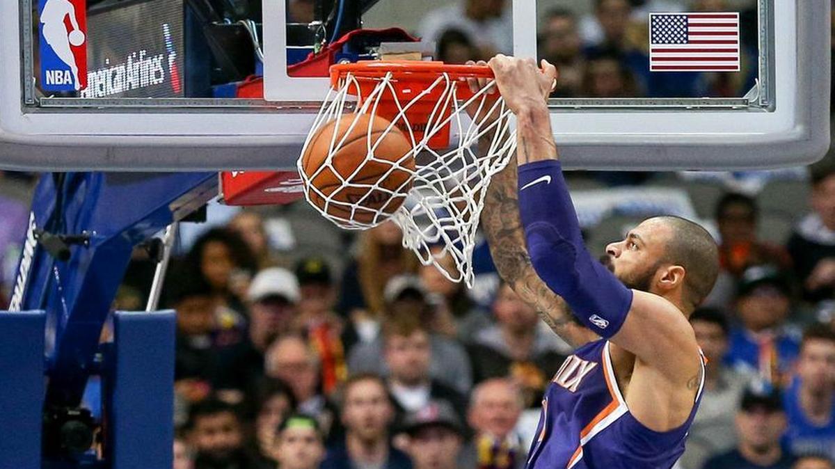 Phoenix Suns center Tyson Chandler slams home two points against his former team, Monday night,.