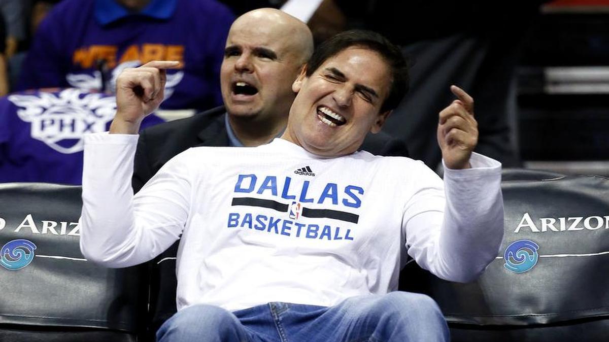 Dallas Mavericks owner Mark Cuban watches his team warm up before Wednesday’s season opener against the Suns in Phoenix.