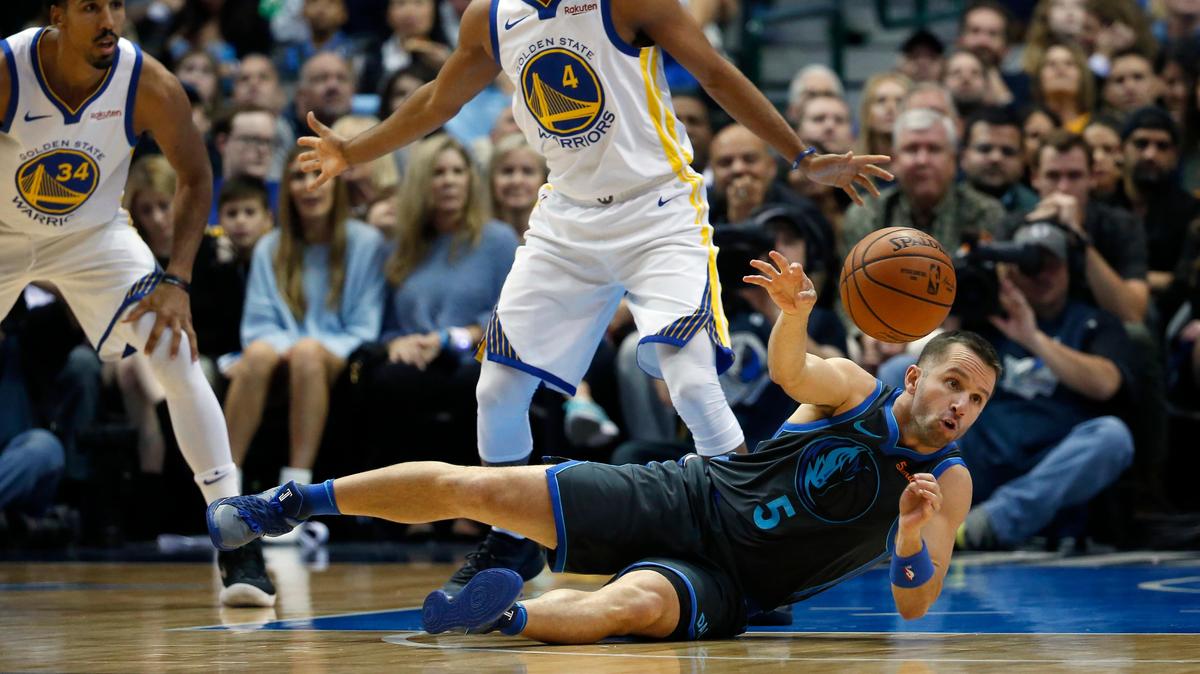 Dallas Mavericks guard J.J. Barea (5) passes from the floor as Golden State Warriors guards Quinn Cook (4) and Shaun Livingston (34) look on during the first half of an NBA basketball game, Saturday, Nov. 17, 2018, in Dallas. (AP Photo/Ron Jenkins)