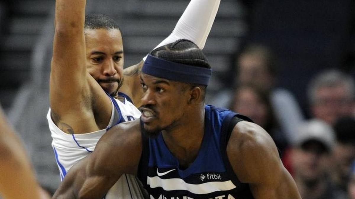 Dallas Mavericks' Devin Harris (34) guards Minnesota Timberwolves' Jimmy Butler (23) during the fourth quarter of an NBA basketball game on Sunday, Dec. 10, 2017, in Minneapolis. The Timberwolves won 97-92.