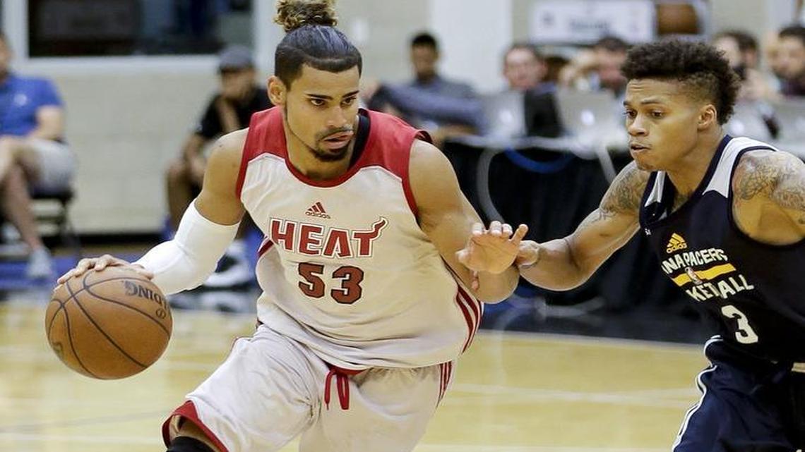 Miami Heat Summer League player Gian Clavell, left, drives around the Indiana Pacers’ Joe Young (3) during the second half of an NBA summer league basketball game, Monday, July 3, 2017, in Orlando, Fla. Clavell has signed a partially guaranteed contract with the Dallas Mavericks as an undrafted free agent.