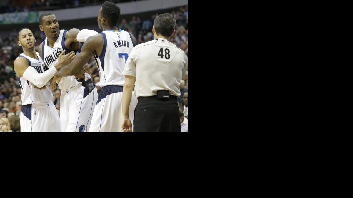 
Dallas Mavericks center Amar’e Stoudemire, center, is restrained by teammates Al-Farouq Aminu (7) and Devin Harris as Stoudemire yells at referee Scott Foster. Stoudemire was ejected after the outburst.



