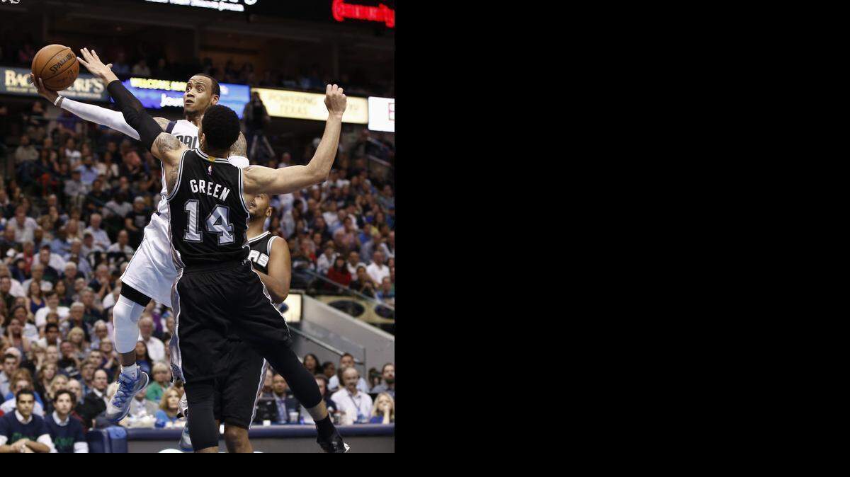 
Mavericks guard Monta Ellis, shooting over Spurs guard Danny Green, has scored 38 points in each of the past two games against San Antonio.
