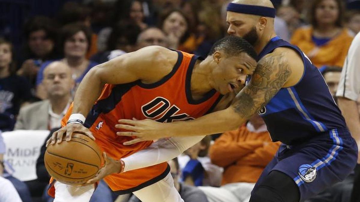 Oklahoma City Thunder guard Russell Westbrook, left, drives around Dallas Mavericks guard Deron Williams during the second quarter.