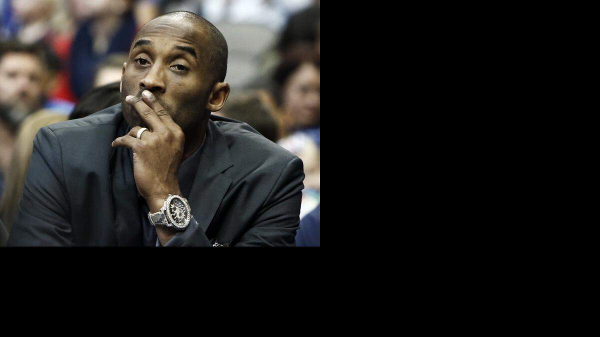 
Los Angeles Lakers guard Kobe Bryant looks on from the bench in the first half of an NBA basketball game against the Dallas Mavericks, Friday, Dec. 26, 2014 in Dallas. 
