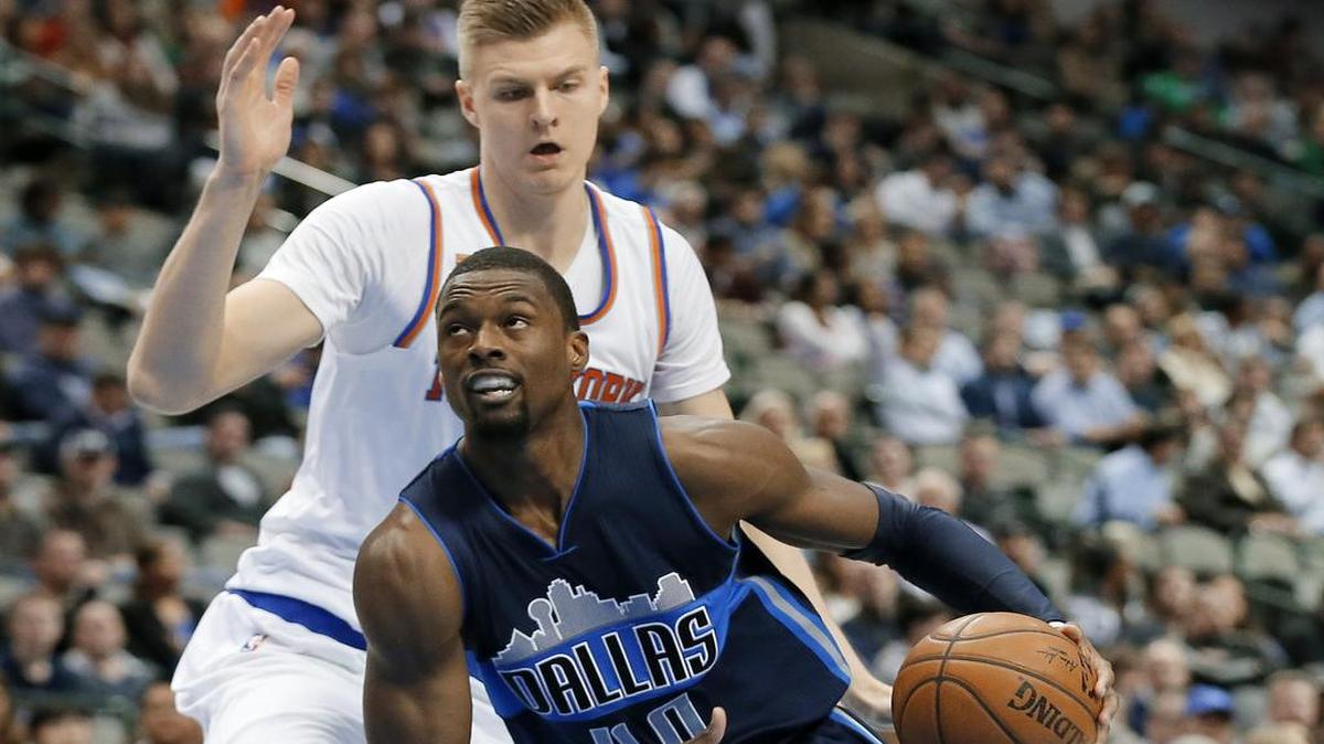 Dallas Mavericks forward Harrison Barnes leans toward the basket trying to distance himself from the 7-foot-3 frame of New York Knicks center Kristaps Porzingis.