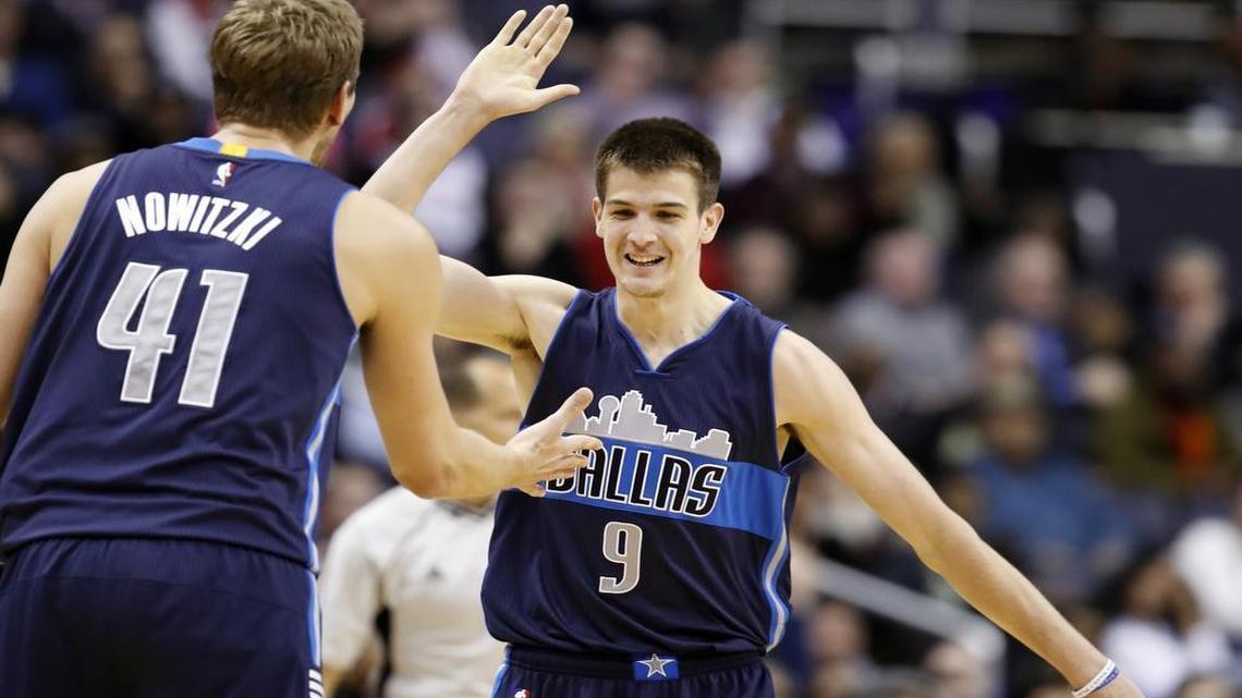 Dallas Mavericks forwards Dirk Nowitzki and Nicolas Brussino celebrate after Burssino’s 3-point basket during the second half of an NBA basketball game against the Washington Wizards on Wednesday in Washington. Dallas won 112-107.