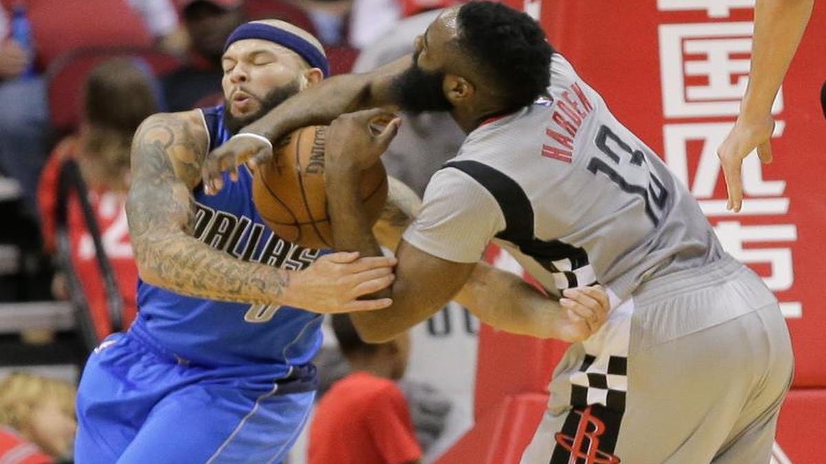 Dallas Mavericks guard Deron Williams (8) fouls Houston Rockets guard James Harden (13) as he drives to the basket during the first half of Sunday in Houston.