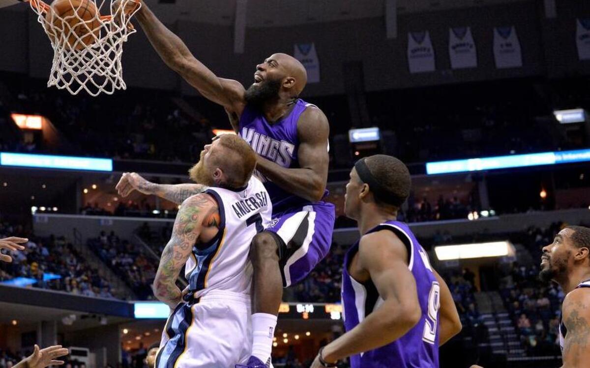 Sacramento Kings forward Quincy Acy, top, dunks the ball against Memphis Grizzlies forward Chris Andersen (7) during the first half of an NBA basketball game. Acy signed a two-year contract with the Dallas Mavericks on Thursday July 14.