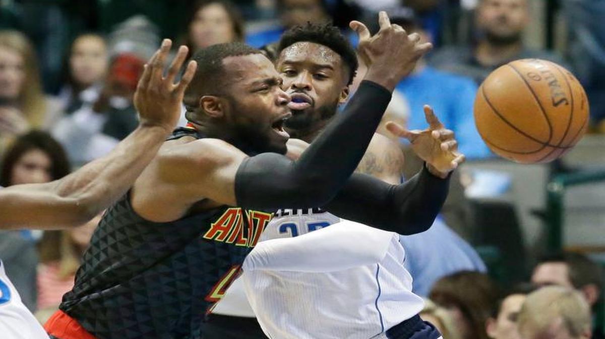 Atlanta Hawks forward Paul Millsap (4) tries to drive past Dallas Mavericks defenders Harrison Barnes (40) and Wesley Matthews (23) during the first half of an NBA basketball game in Dallas, Saturday, Jan. 7, 2017.