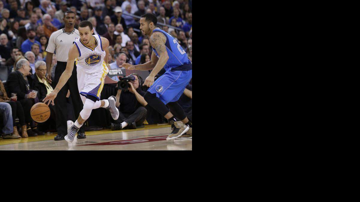 
Stephen Curry, left, scored 51 points to lead the Warriors past Devin Harris and the Mavericks 128-114 on Feb. 4 in Oakland, Calif. The teams meet again Friday.


