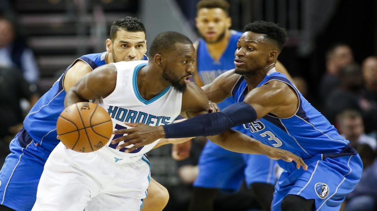 Kemba Walker, left, scored 18 points Thursday to help the Hornets fend off the Mavericks 97-87 in Charlotte.