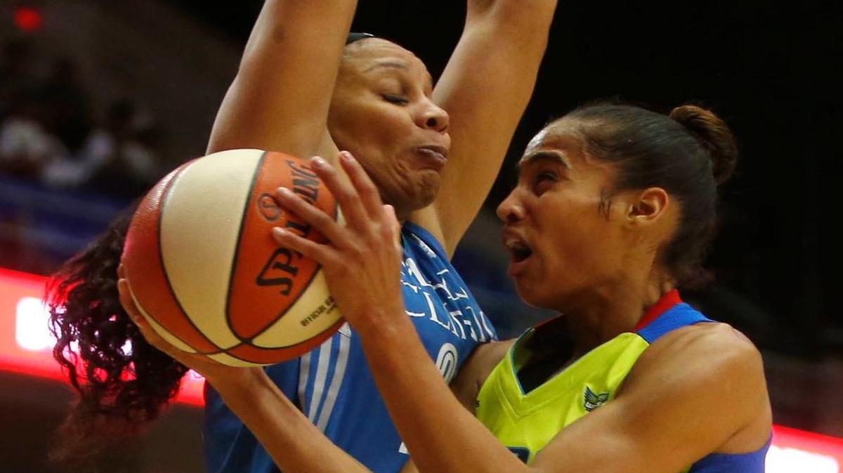 Dallas Wings guard Skylar Diggins-Smith, right, goes up for a shot against Minnesota Lynx forward Plenette Pierson in the first quarter of a WNBA basketball game in Arlington.