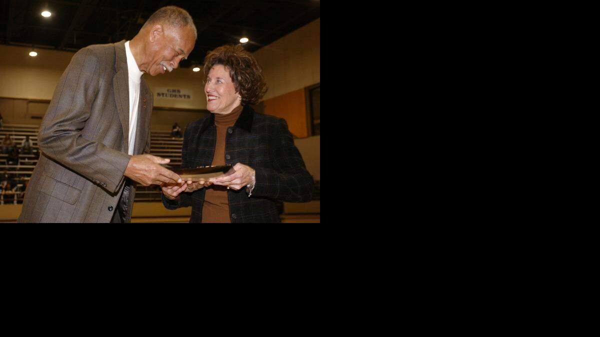 
Retired Fort Worth Dunbar coach Robert Hughes (the boys all-time winningest coach) presents Granbury girls coach Leta Andrews, the new all-time winningest girls basketball coach in the country, with a platter honoring her achievement at Granbury High School gym at Dec. 10, 2005.
