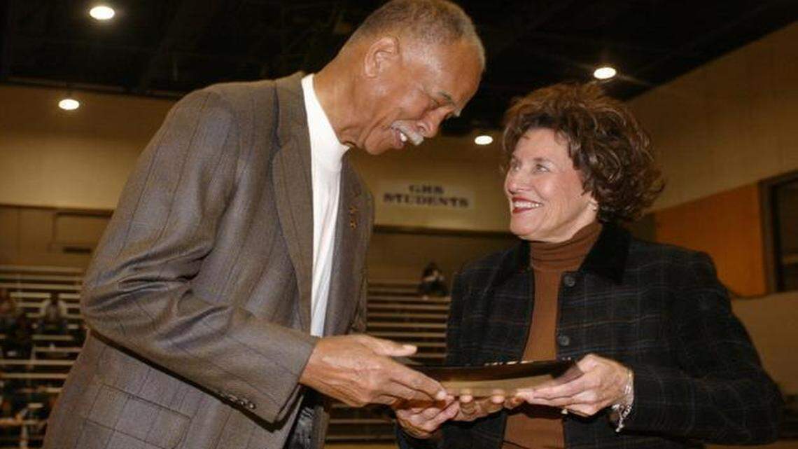 
Retired Dunbar coach Robert Hughes (the boys all-time winningest coach) presents Granbury girls coach Leta Andrews, the all-time winningest girls basketball coach, with a platter honoring her achievement during a celebration in 2005. 
