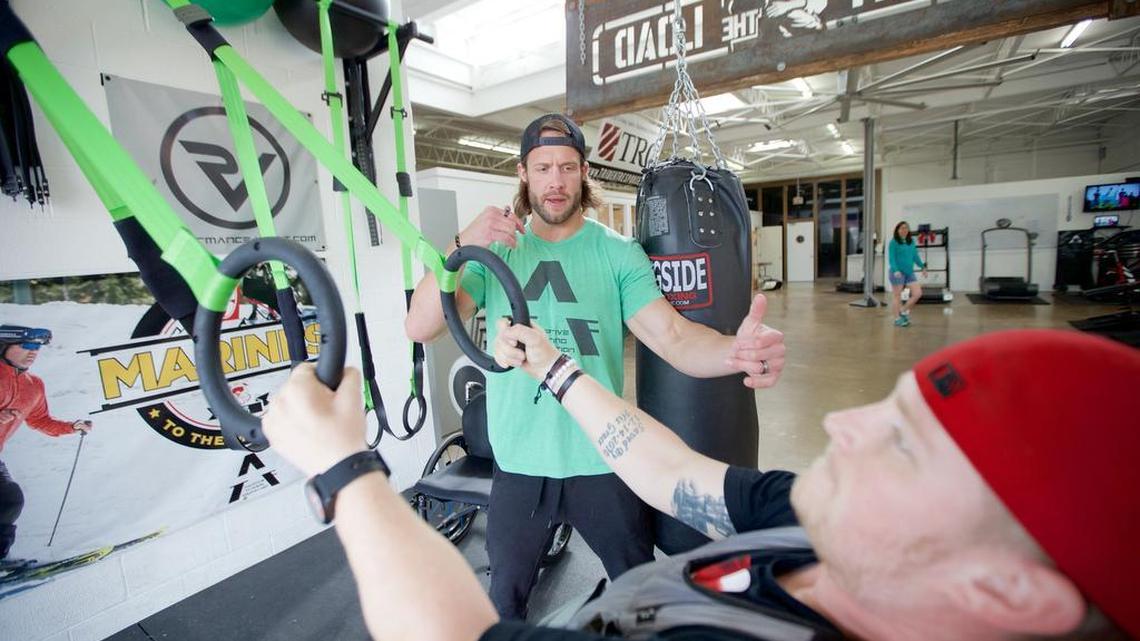 David Vobora coaches Blake Watson through an upper-body exercise at the Adaptive Training Foundation's training center in Dallas.