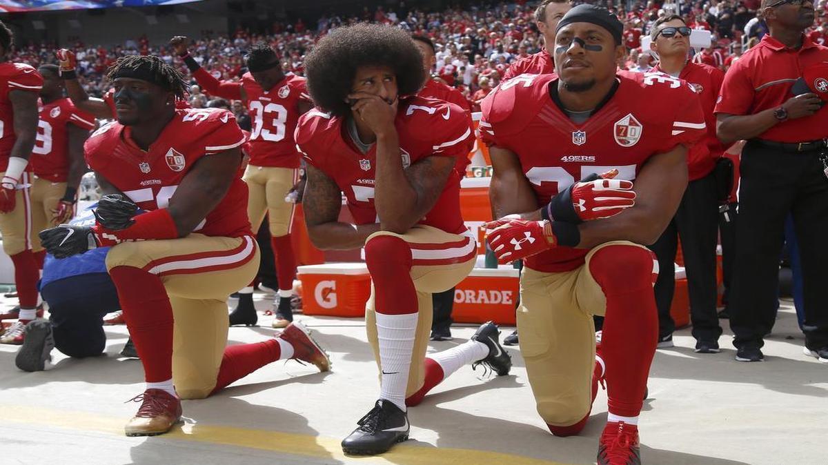 San Francisco 49ers Eli Harold, quarterback Colin Kaepernick and Eric Reid, from left, kneel during the national anthem before their game against the Dallas Cowboys on Oct. 2, 2016, in Santa Clara, Calif.