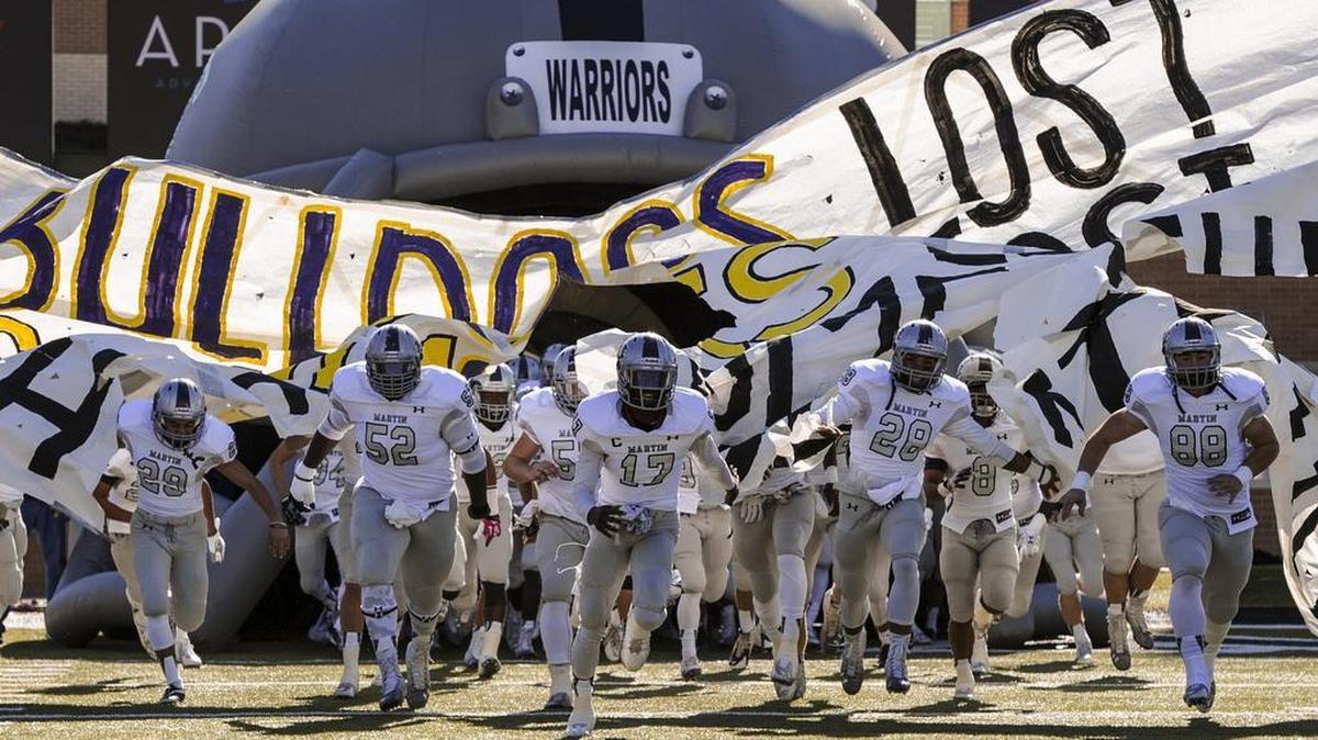 
Busting through a banner is the traditional way for players to take the field, a la the Arlington Martin Warriors before a playoff game in 2014.

