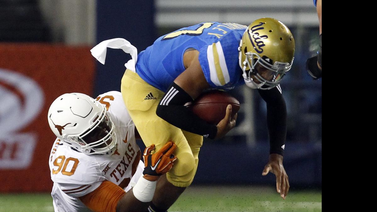 
Texas defensive tackle Malcom Brown, shown sacking UCLA quarterback Brett Hundley, went to the Patriots with the No. 32 choice Thursday. 
