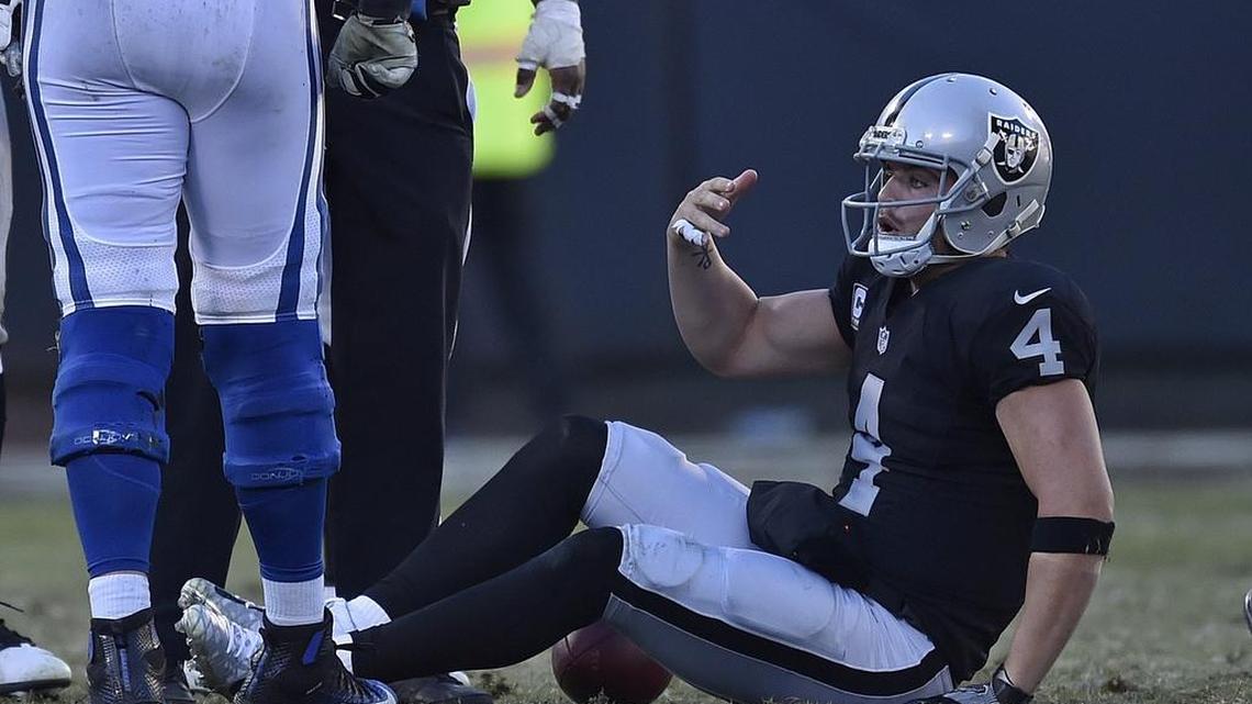 Oakland Raiders quarterback Derek Carr (4) suffers a broken leg after being tackled by the Indianapolis Colts’ Trent Cole in the fourth quarter at the Coliseum in Oakland, Calif., on Saturday, Dec. 24, 2016.